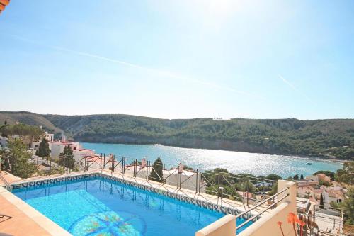 a swimming pool with a view of a lake at Villa Isabelle in L'Escala