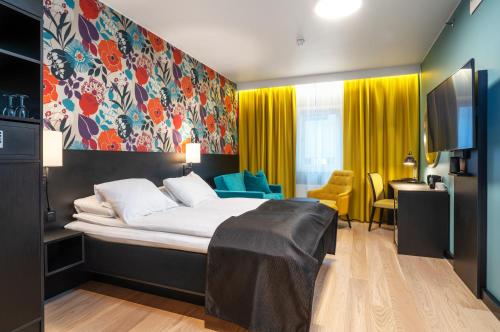 a hotel room with a bed and a tv at Thon Hotel Harstad in Harstad