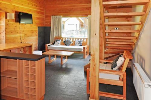 a room with two bunk beds and a staircase at Complejo Turistico Los Hualles in Las Trancas