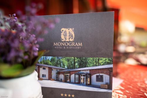 a sign for a morgan hotel and facility at Hotel & Distillery Monogram in Mišići