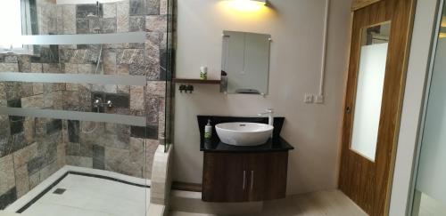 a bathroom with a sink and a shower at Le Morne Kite Villas - Penthouse in La Gaulette