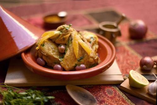 a bowl of food on a table with a knife at Riad Shaden in Marrakech