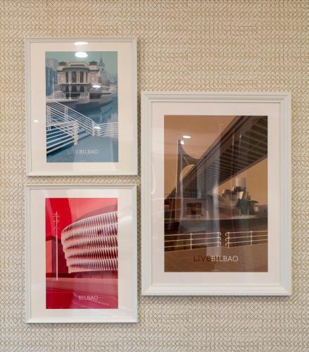 a trio of three pictures hanging on a wall at Santiago Apartments Bilbao in Bilbao