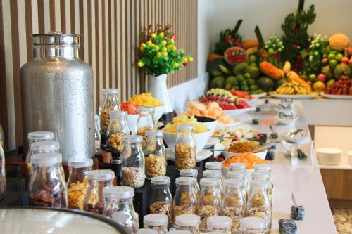 a table with many jars of food and fruit at OZO Phuket in Kata Beach