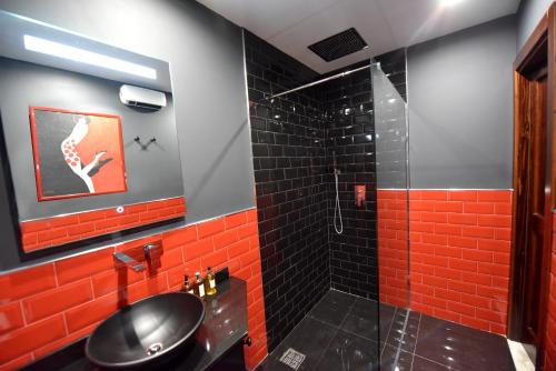 a bathroom with red tile and a shower at The Lodge in Cospicua