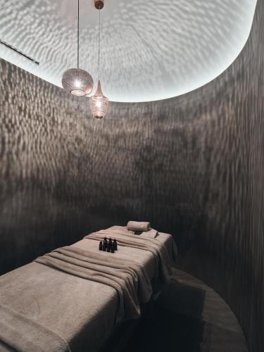 a room with a bed and two lights on a wall at Contessina Suites & Spa - Adults Only in Tsilivi