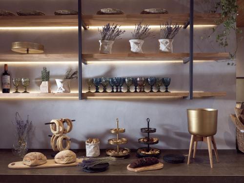 a shelf filled with lots of glasses and other items at Contessina Suites & Spa - Adults Only in Tsilivi