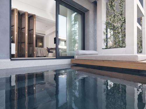 a house with a swimming pool in front of a house at Contessina Suites & Spa - Adults Only in Tsilivi