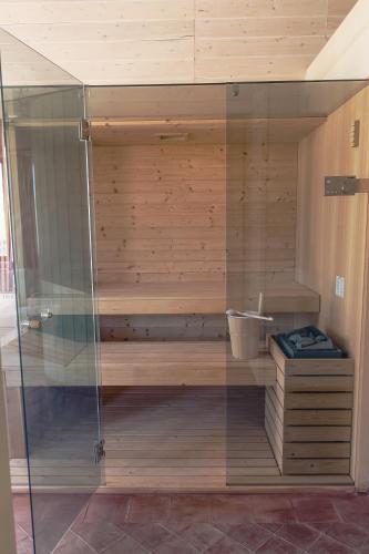 a sauna with a glass shower in a room at Le Querce di Cota in Troina