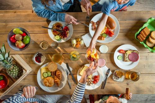 a group of people sitting around a table with food at Center Parcs De Eemhof in Zeewolde