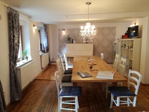 a dining room with a wooden table and chairs at Castle Hotel in Regensburg