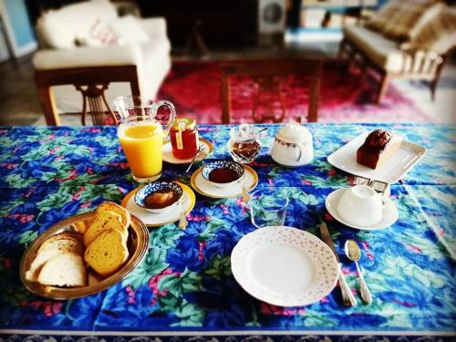 a table with a breakfast of bread and orange juice at Podere684 in Grosseto