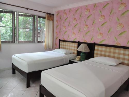 En eller flere senge i et værelse på Changpuak Hotel