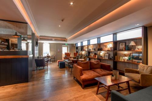 a living room with a couch and a table at The Raeburn in Edinburgh