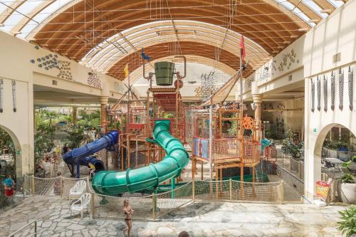 a indoor playground in a mall with a slide at Hotel Hochsauerland by Center Parcs in Medebach