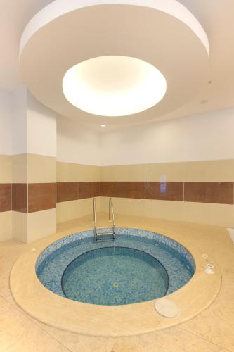 a large pool of water in a room with a ceiling at Mercure Istanbul Bakirkoy in Istanbul