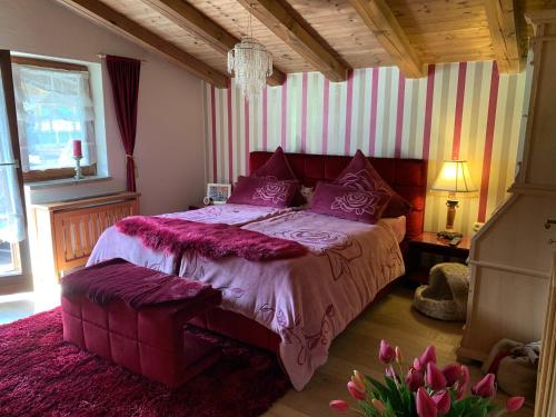 a bedroom with a large bed with purple pillows at Gästehaus Wimmer in Mittersill