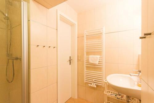 a white bathroom with a sink and a shower at Ferienhof Schön in Zempin