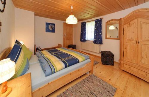a bedroom with a bed and a wooden ceiling at Ferienhof Degenhart in Mauth