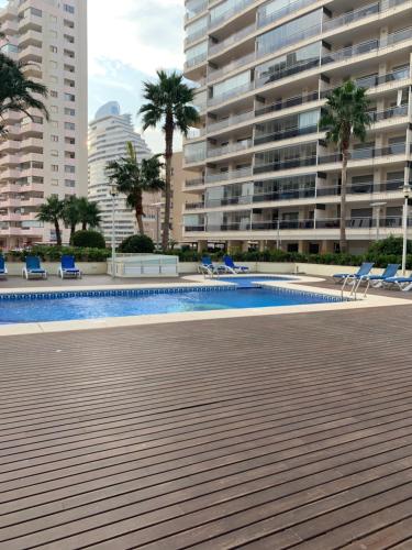 a swimming pool in front of a large building at Vista Bella Apartment in Calpe