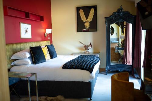 a bedroom with a large bed and a mirror at Frasers in Egerton