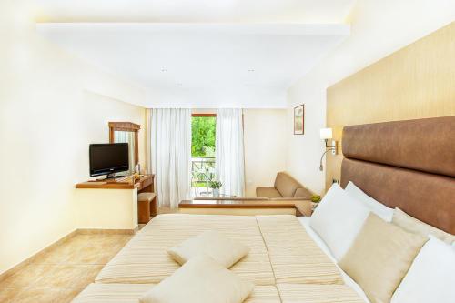 a hotel room with a bed and a couch at Hotel Europa Olympia in Olympia