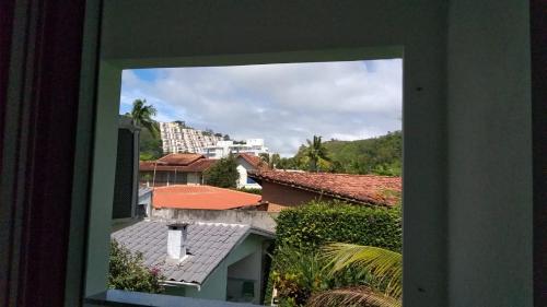 a view of a city from a window at Kitnets & Flats in Ubatuba
