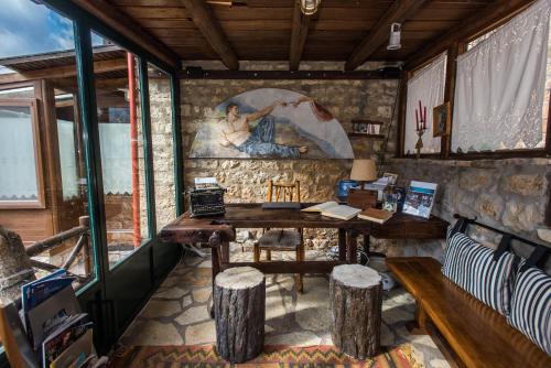 a room with a table and a painting on the wall at Μαγεμένο Βουνό in Karpenision