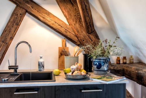 a kitchen counter with a sink and a bowl of fruit at Palais Wunderlich in Lahr
