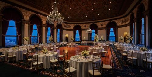 a banquet hall with tables and chairs and a chandelier at Graduate by Hilton Providence in Providence