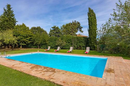a swimming pool in a yard with lounge chairs at Agriturismo Etrusco in Murlo