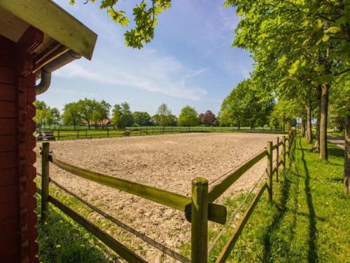 a wooden fence in front of a field at Ekenhoff in Moorweg