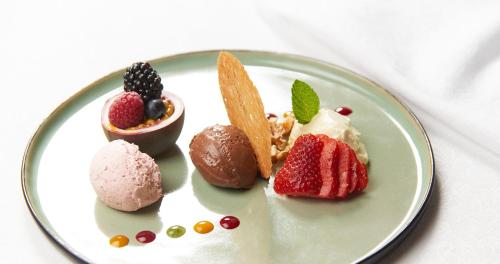 a plate with different types of desserts on it at Schlosshotel Dörflinger in Bludenz