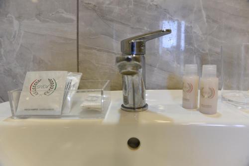 a sink with a faucet and two bottles of soap at Ville Vesuviane in San Giorgio a Cremano