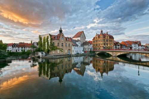 a city with a bridge over a river with buildings at KNAUS Campingpark Eschwege in Eschwege