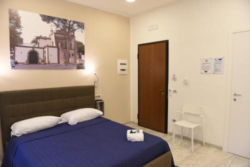 a bedroom with a bed with a blue comforter at Ville Vesuviane in San Giorgio a Cremano