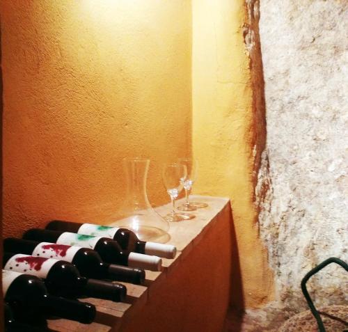 a bunch of wine bottles and glasses on a table at monmossen bocairent in Bocairent