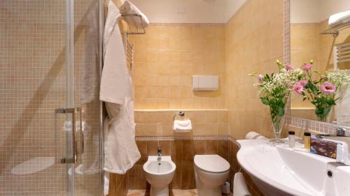 a bathroom with a sink and a toilet and a shower at Abbazia Collemedio Resort & Spa in Collazzone