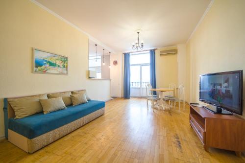 a living room with a couch and a flat screen tv at Central Dayflat Apartments in Kyiv