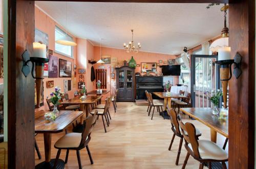 a dining room with wooden tables and chairs at KNAUS Campingpark Essen in Essen