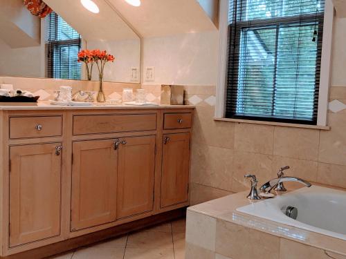 a bathroom with a sink and a large mirror at The Inn at Montchanin Village & Spa in Montchanin