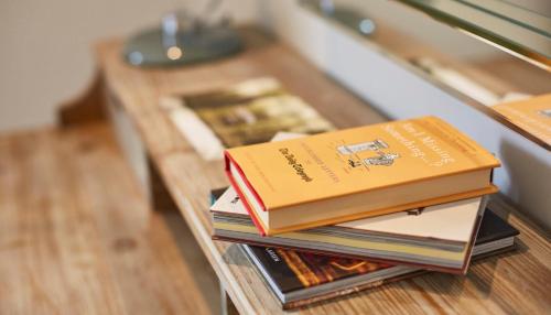 a stack of books sitting on a table at The Swan, Streatley, Berkshire in Streatley