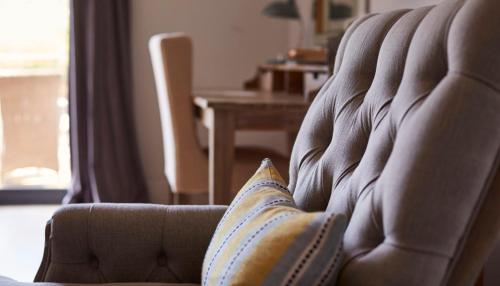 a pillow sitting on a chair in a living room at The Swan, Streatley, Berkshire in Streatley