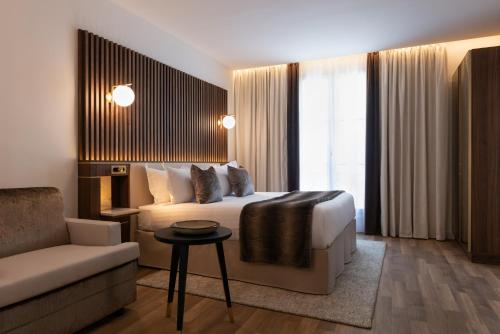 a hotel room with a bed and a couch at Lord Byron in Paris