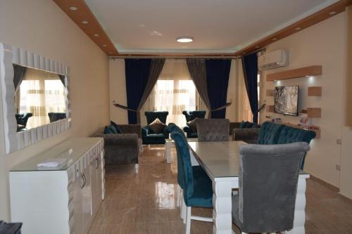a living room with a table and chairs at Ramco For Furnished Apartments And Accommodation Compound Leila in Cairo