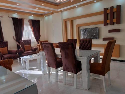 a room with a table and chairs and a couch at Ramco For Furnished Apartments And Accommodation Compound Leila in Cairo