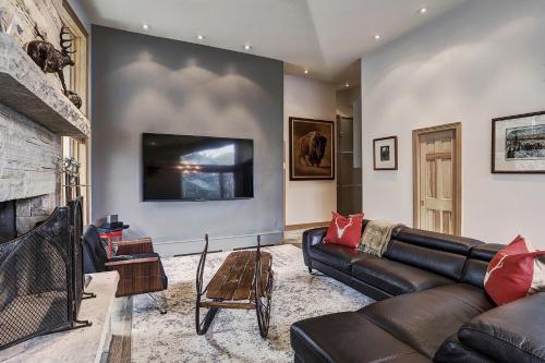 a living room with a leather couch and a fireplace at Lodge at Vail, A RockResort in Vail