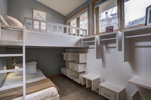 a small room with bunk beds and a window at Lodge at Vail, A RockResort in Vail
