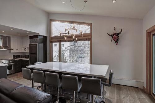 a kitchen and dining room with a table and chairs at Lodge at Vail, A RockResort in Vail