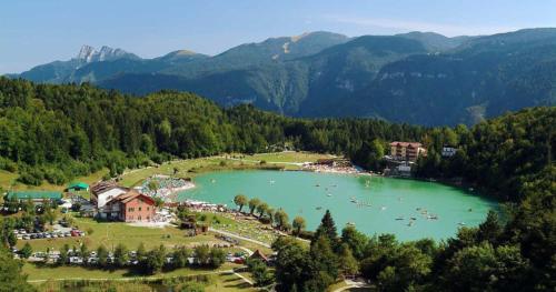 a group of people in a lake in the mountains at Erica in Folgaria